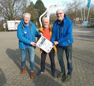 Zoolauf Münster 2023: Die Veranstalter vor dem Allwetterzoo mit Plakat in der Hand